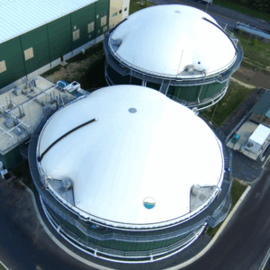 Maryland Bioenergy Center's green anaerobic digestion tanks with white tops